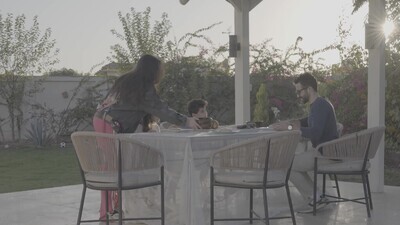 a family preparing a dining table in the garden