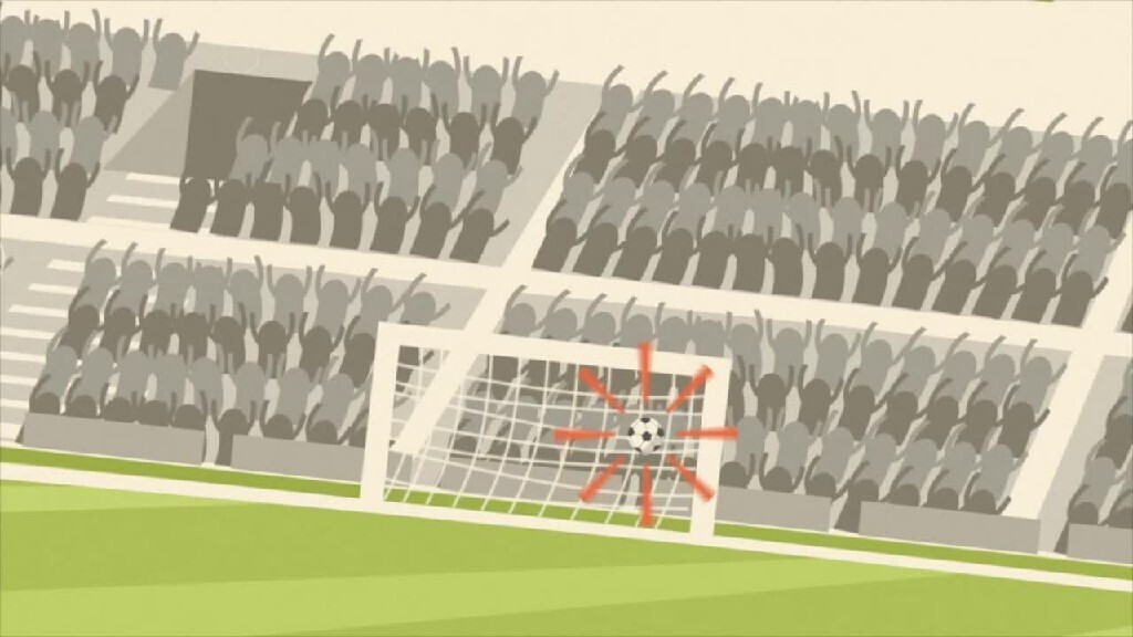 a man kicks a football on the stadium