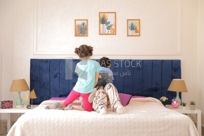a woman sitting with her children playing