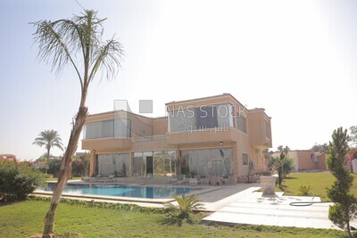 View of the house with a swimming pool and garden