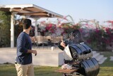 woman preparing food on a barbecue grill