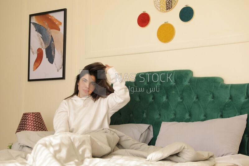 a woman sitting in bed waking up