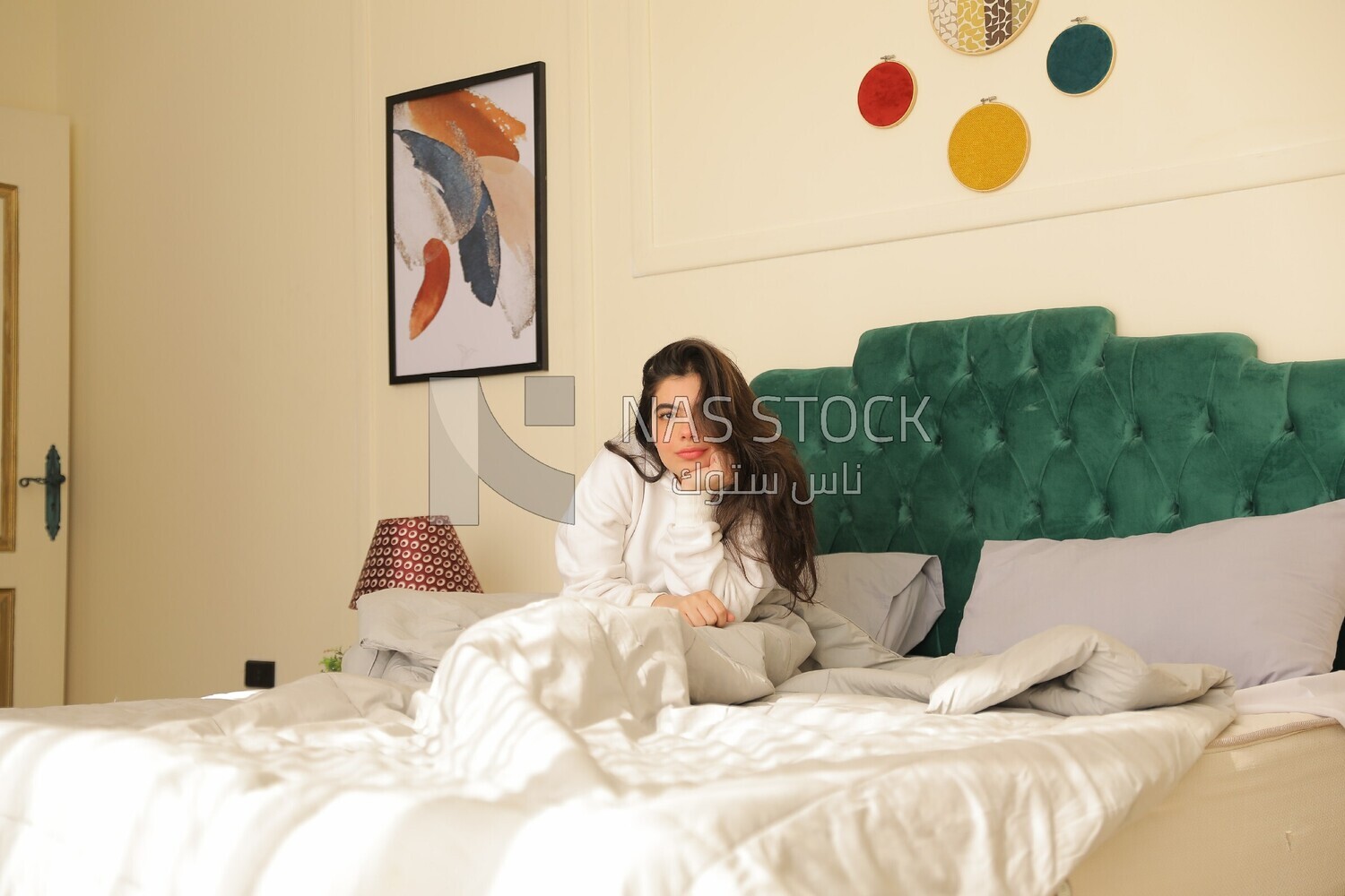 a woman sitting on the bed