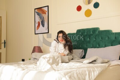 a woman sitting on the bed