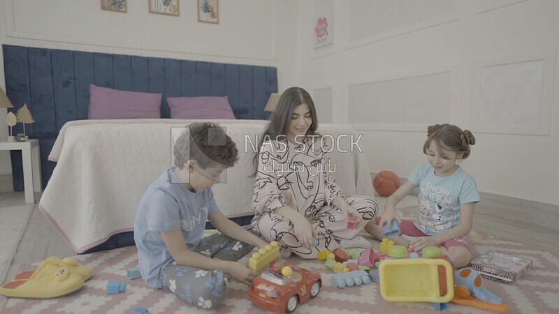 a woman sitting with her children playing