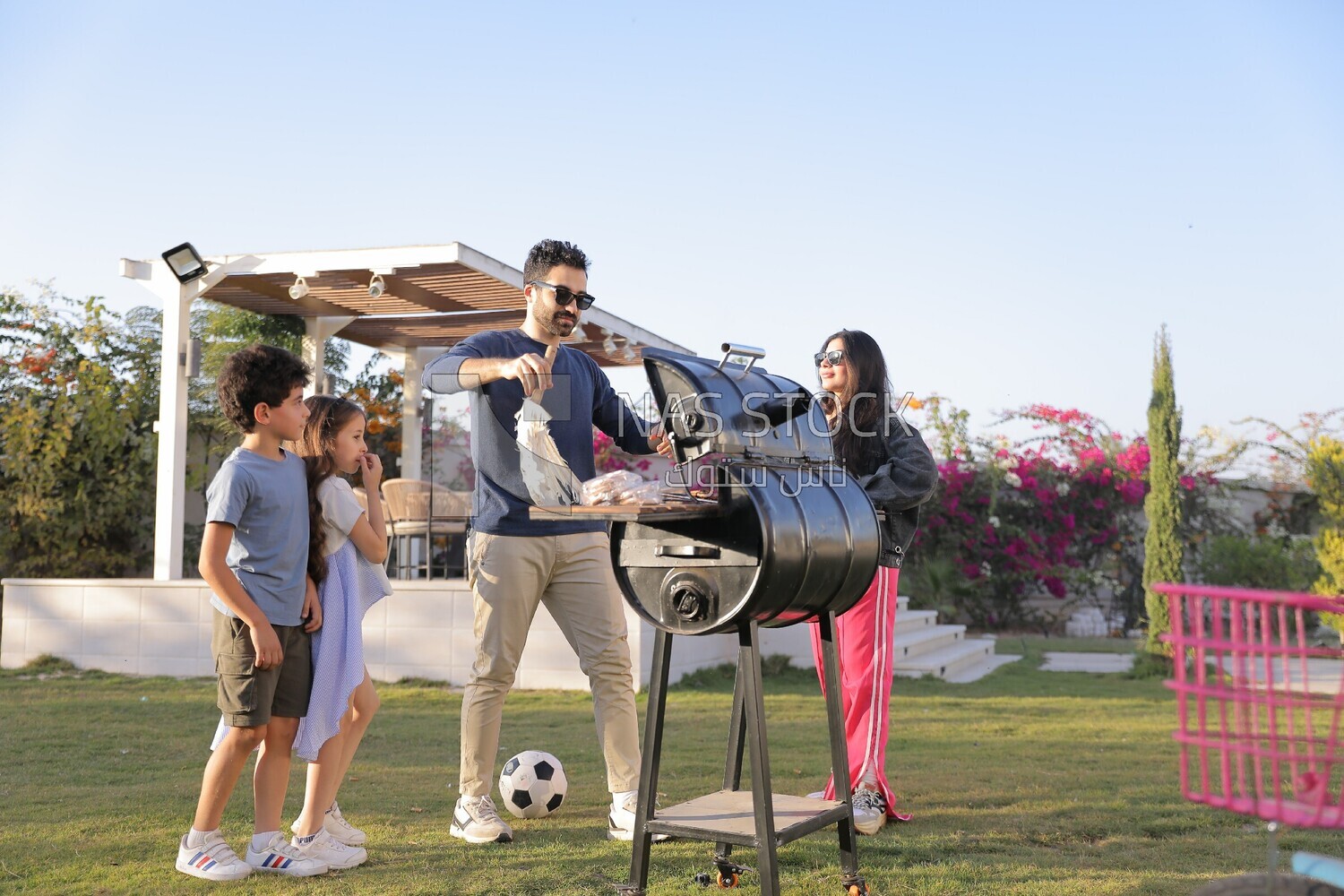 man preparing food on a barbecue grill