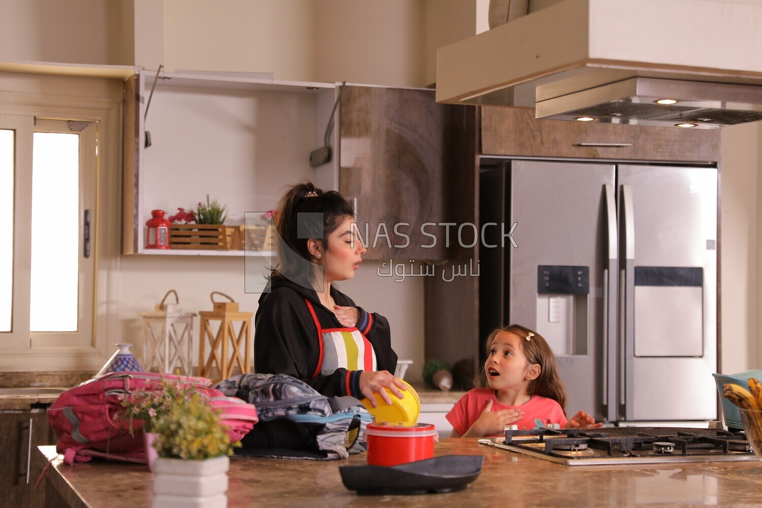 a mother with her girl in the kitchen