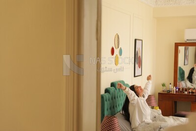 a woman sitting in bed waking up