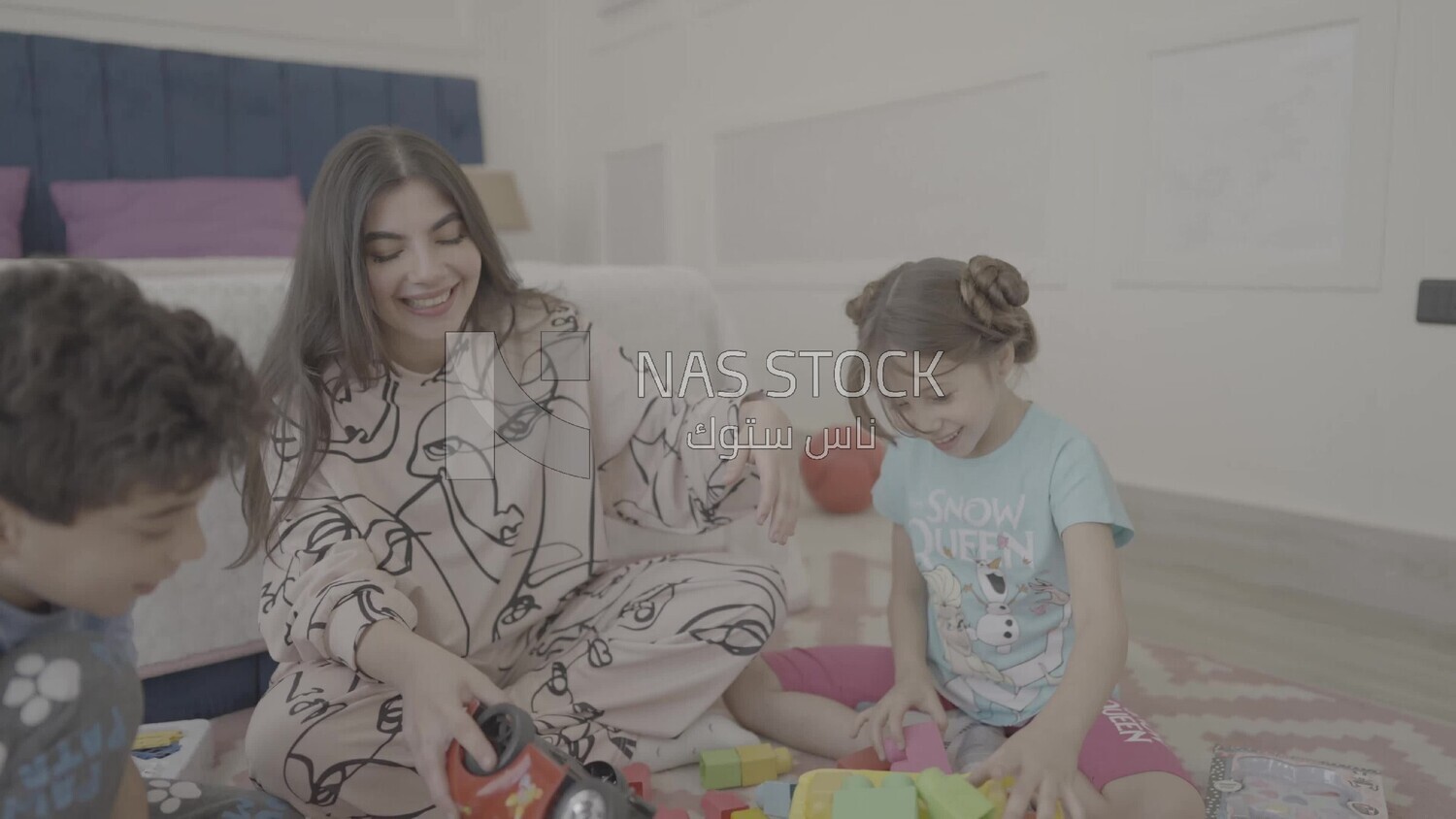 a woman sitting with her children playing