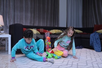 a brother and a sister playing in the living room