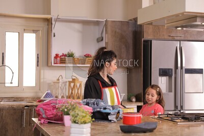 a mother with her girl in the kitchen
