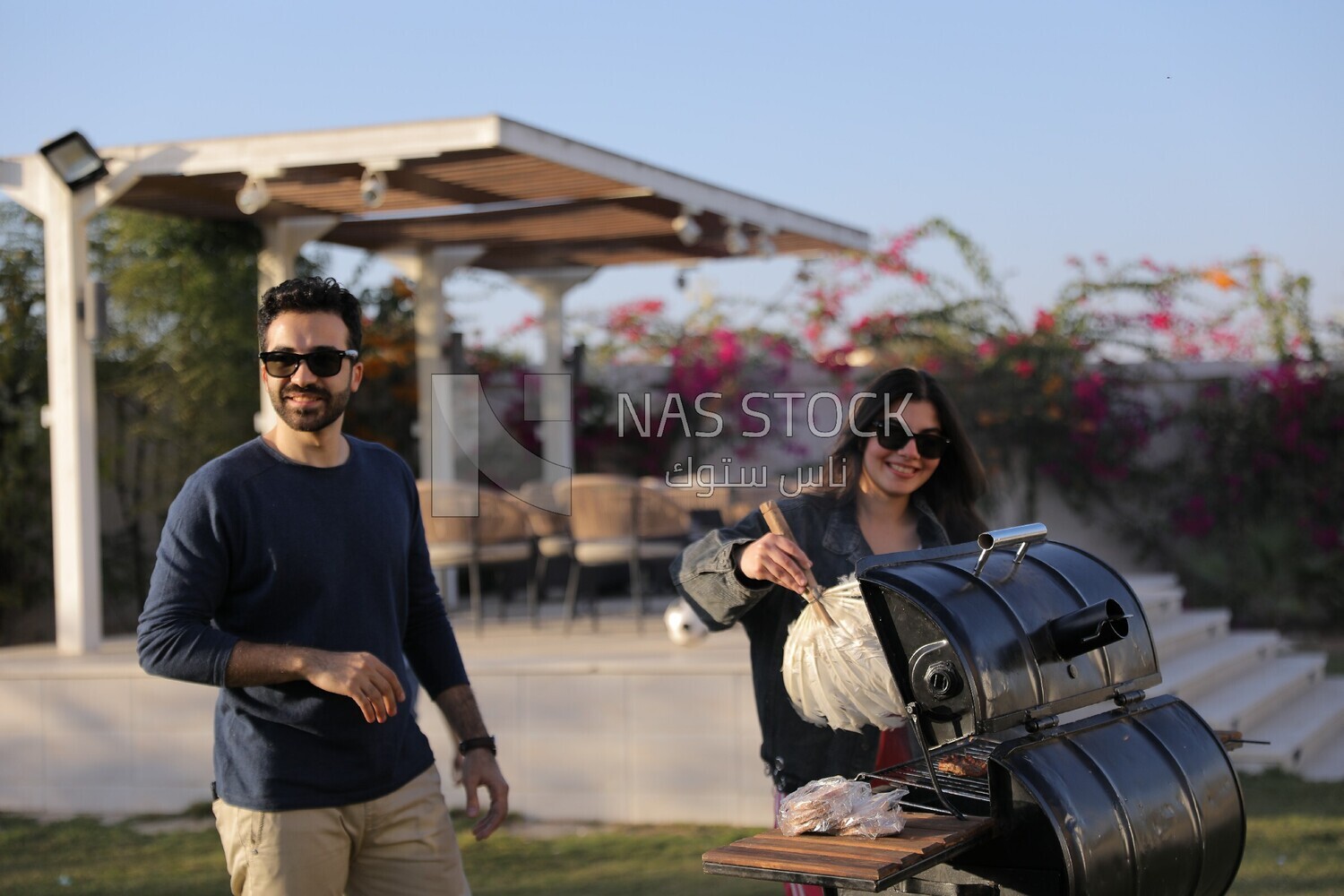 woman preparing food on a barbecue grill