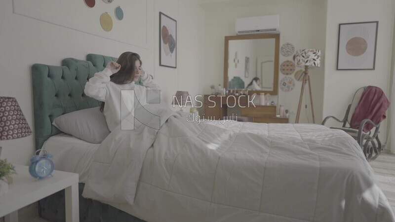 a woman sitting in bed waking up