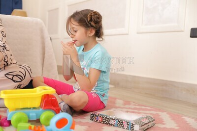 a girl putting on make up while she plays