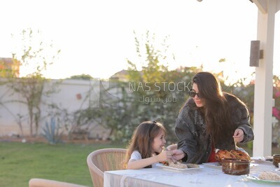 a mother feeding her daughter