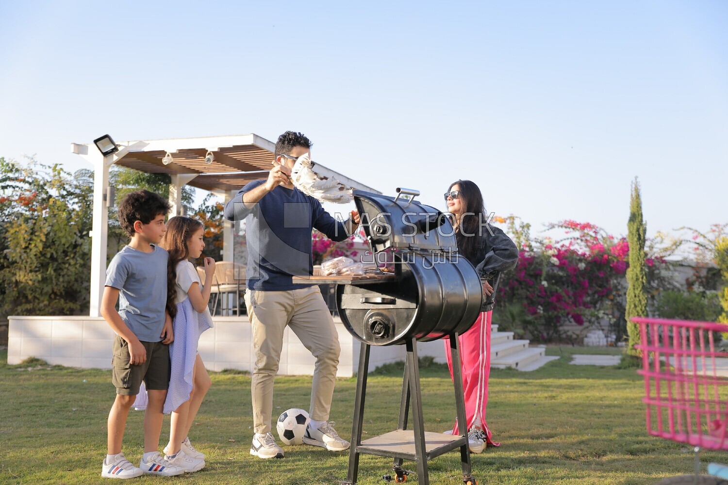 man preparing food on a barbecue grill