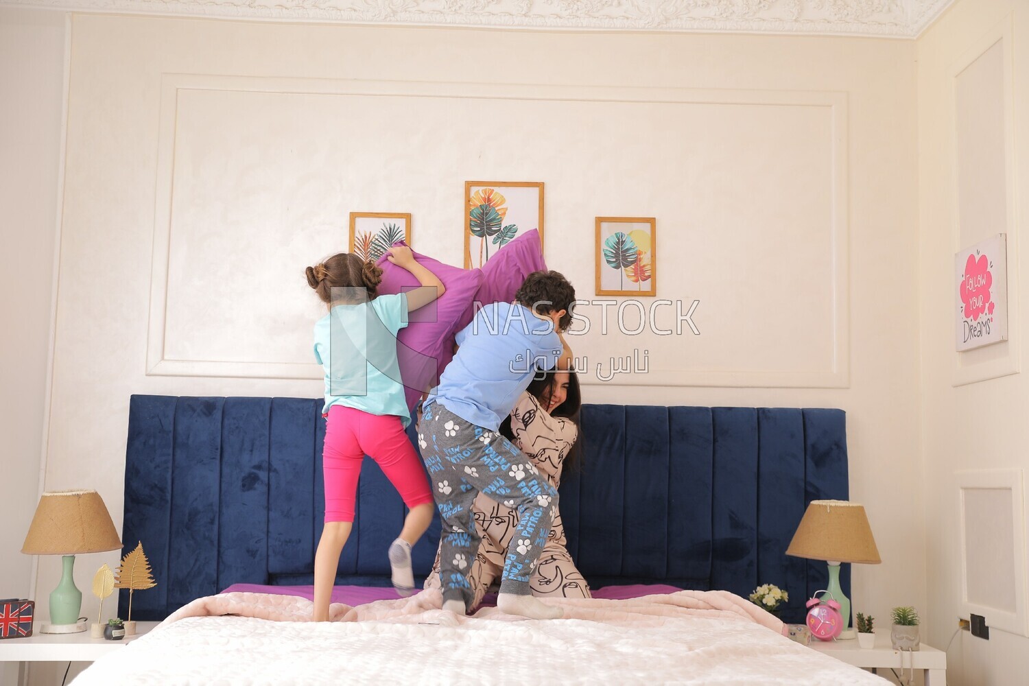 a woman sitting with her children playing