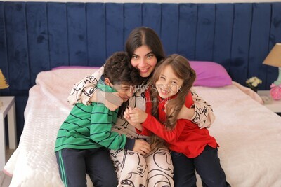 a mother hugging her kids before going to the school