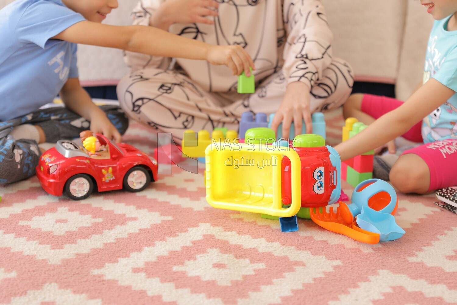 a woman sitting with her children playing