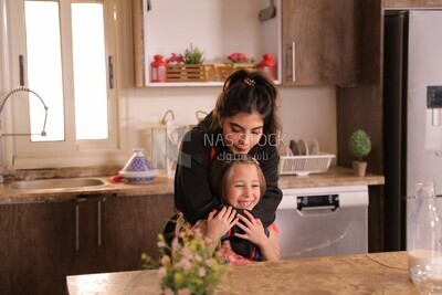 a mother with her girl in the kitchen