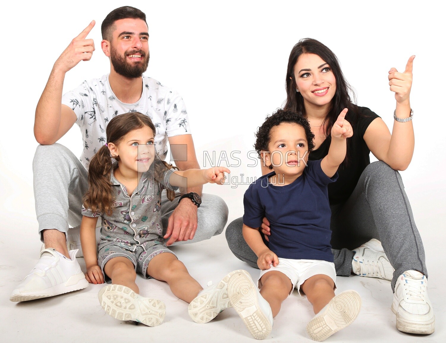 A family of four sitting on the floor