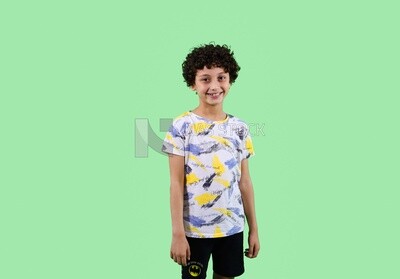 A boy standing on a green background