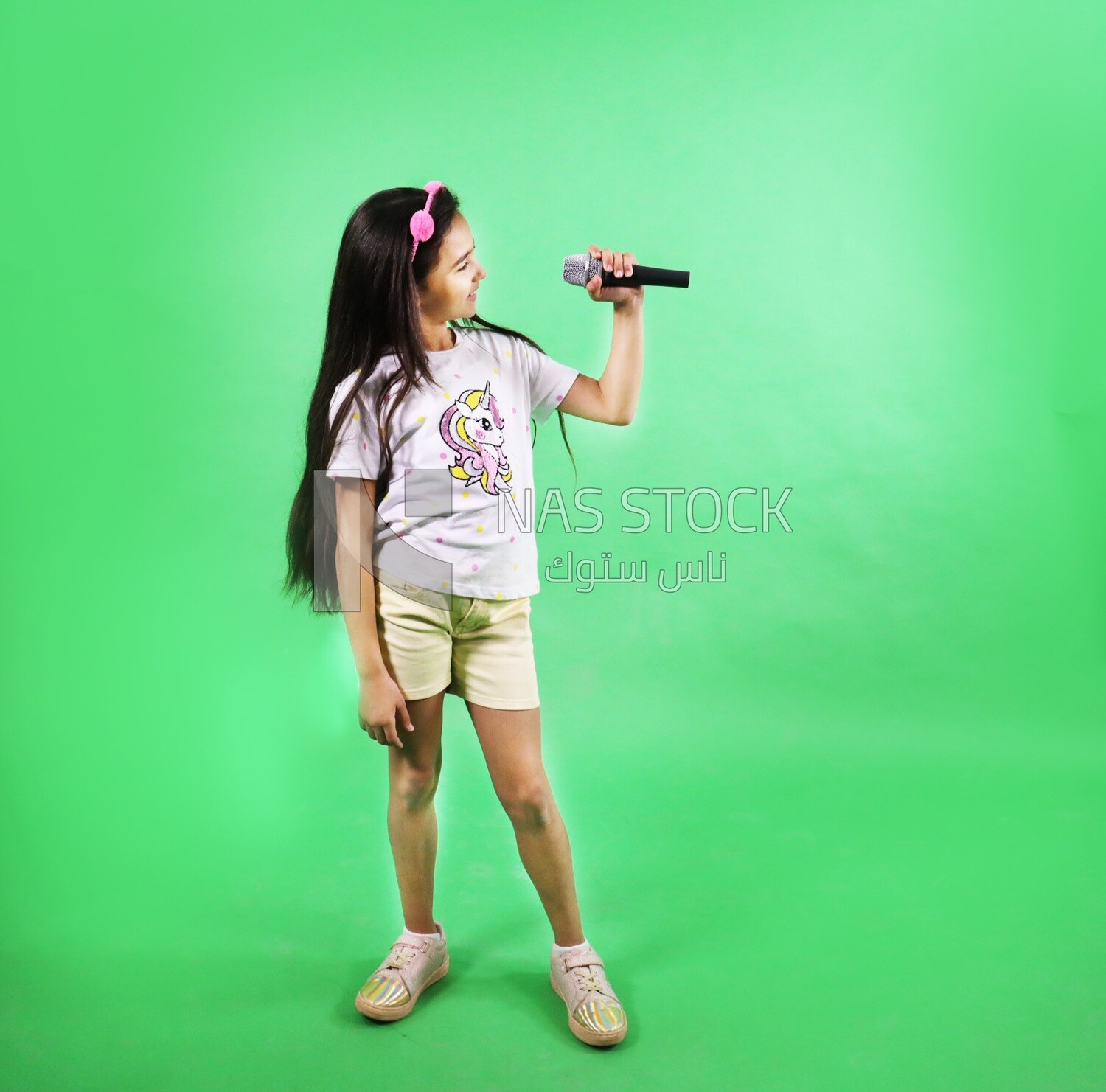 Small girl holding a microphone