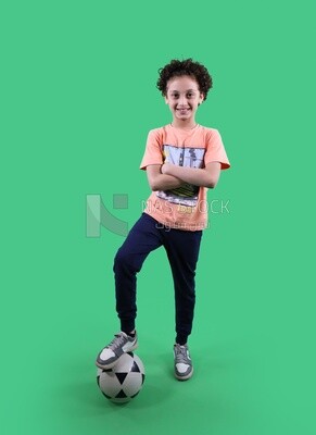 A boy standing with a soccer ball