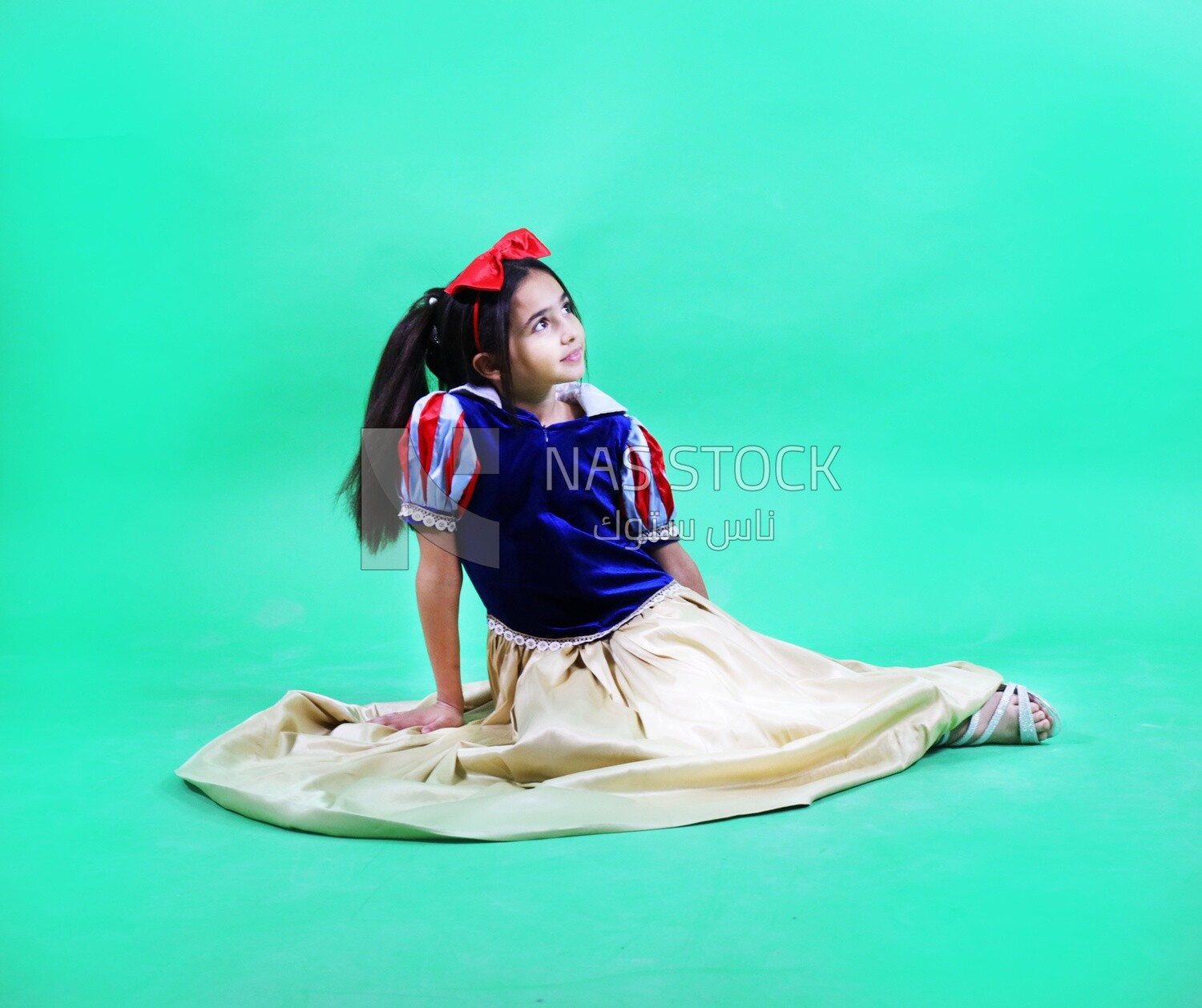 A small girl wearing a disney princess snow white costum
