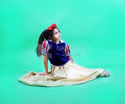 A small girl wearing a disney princess snow white costum