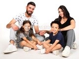 A family of four sitting on the floor