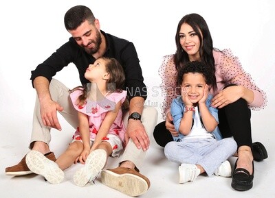 A family of four sitting on the floor