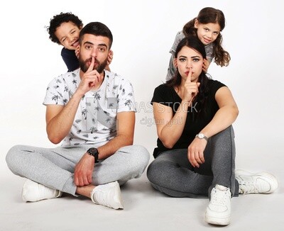 A family of four sitting on the floor