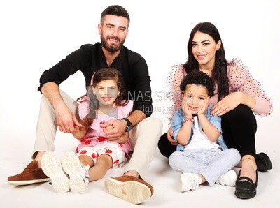 A family of four sitting on the floor