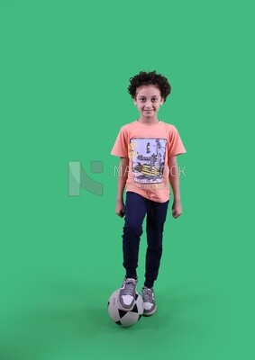 A boy standing with a soccer ball