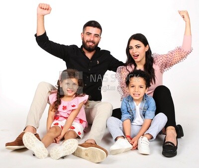 A family of four sitting on the floor