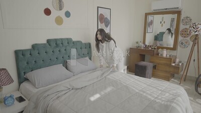 a woman making the bed after she wakes up