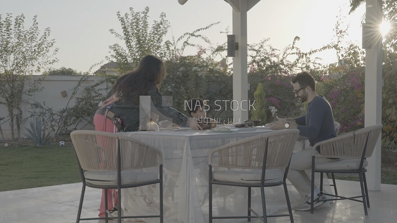 a family preparing a dining table in the garden