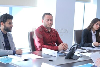 A group of people sitting in the meeting room