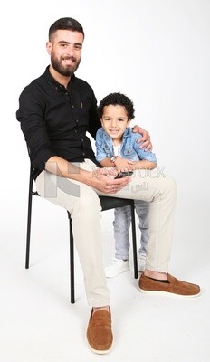 A man sitting on the chair with his boy
