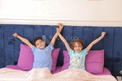 a brother and his sister lying in bed