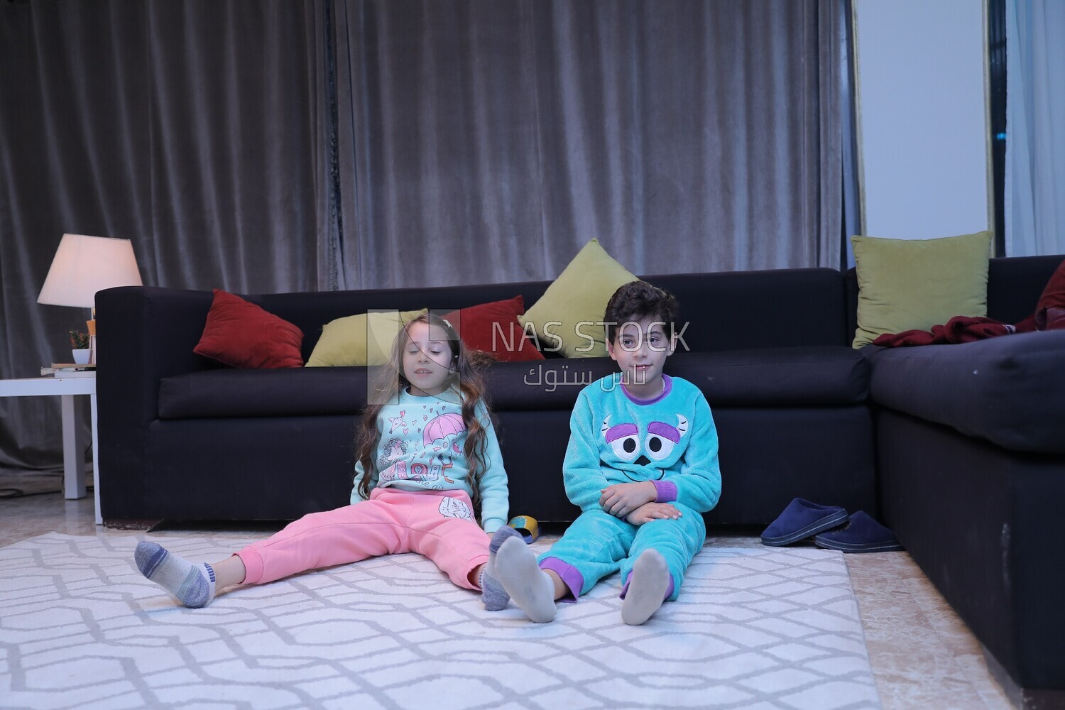 a brother and a sister playing in the living room
