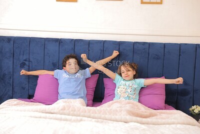 a brother and his sister lying in bed