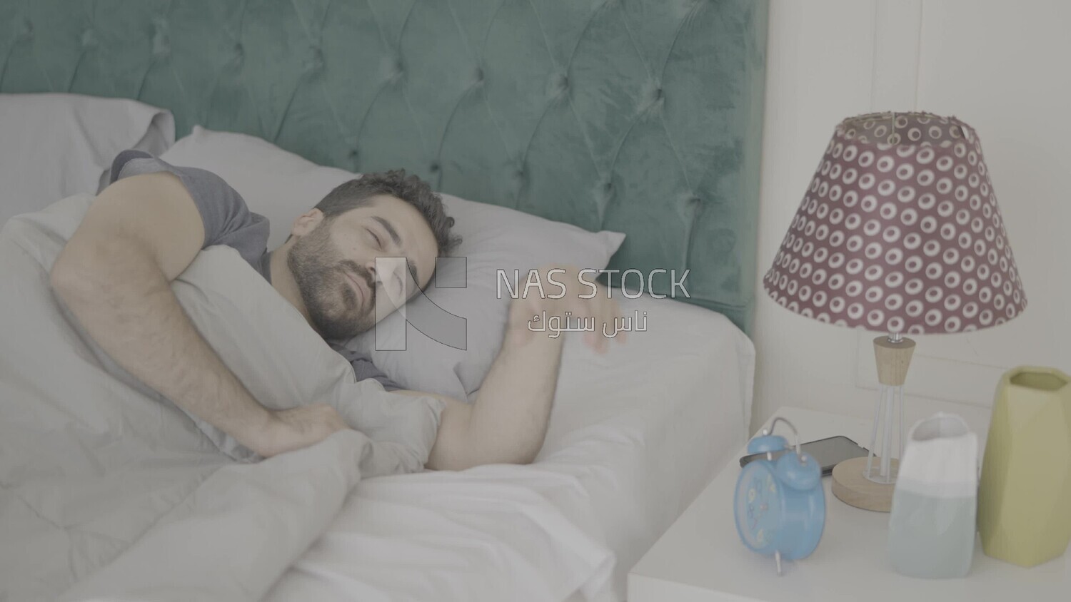 a man  sitting in bed waking up
