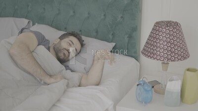 a man  sitting in bed waking up