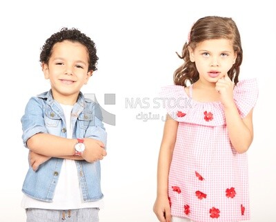 A boy and a girl standing on a white background