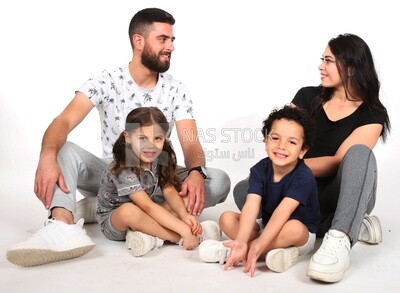 A family of four sitting on the floor