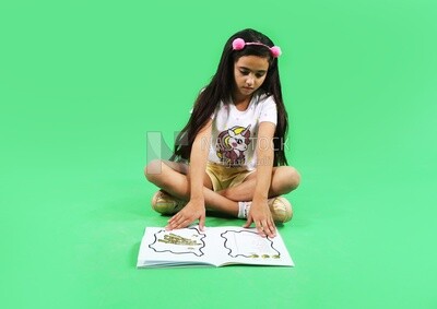 A small girl sitting on the floor and reading a book