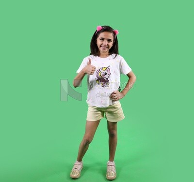A small girl standing on a green background