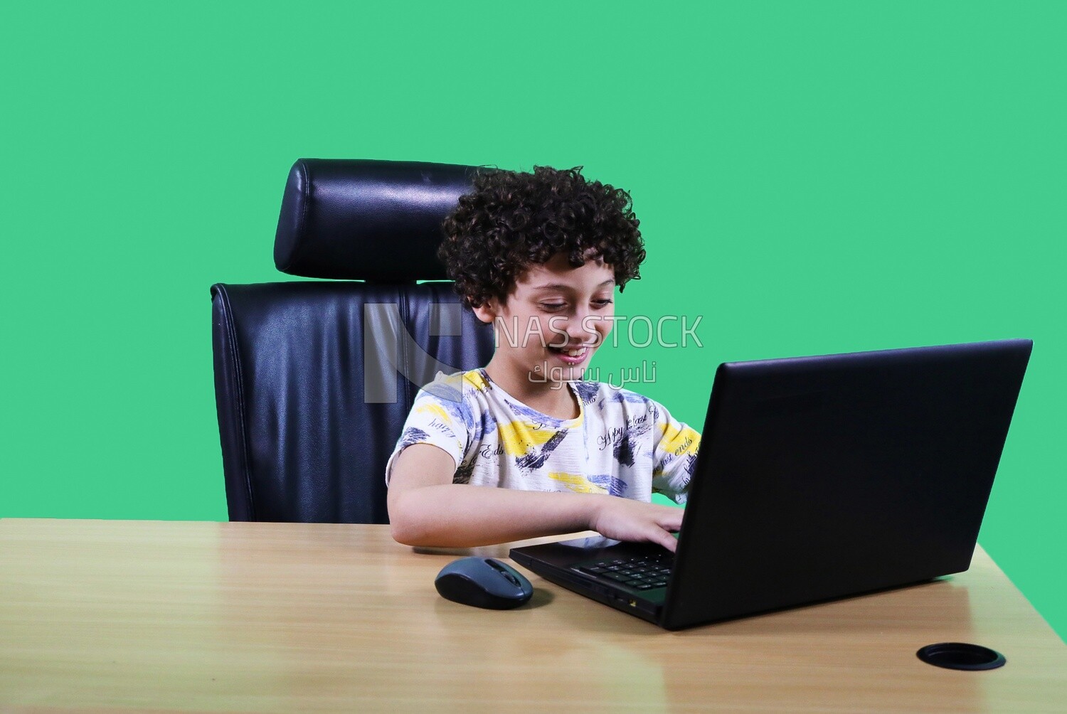 A boy sitting in the office in front of the laptop